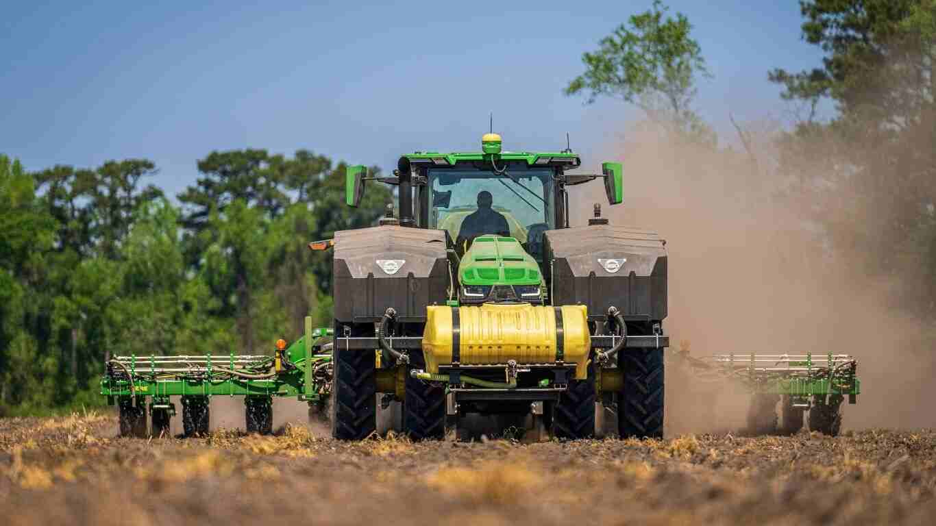 Krone Butterfly Mower working in a green field with tractor