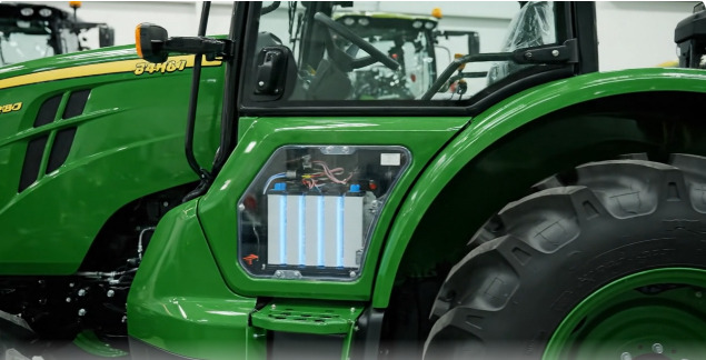 A close-up of a farmer performing tractor battery maintenance, cleaning the corroded terminals.